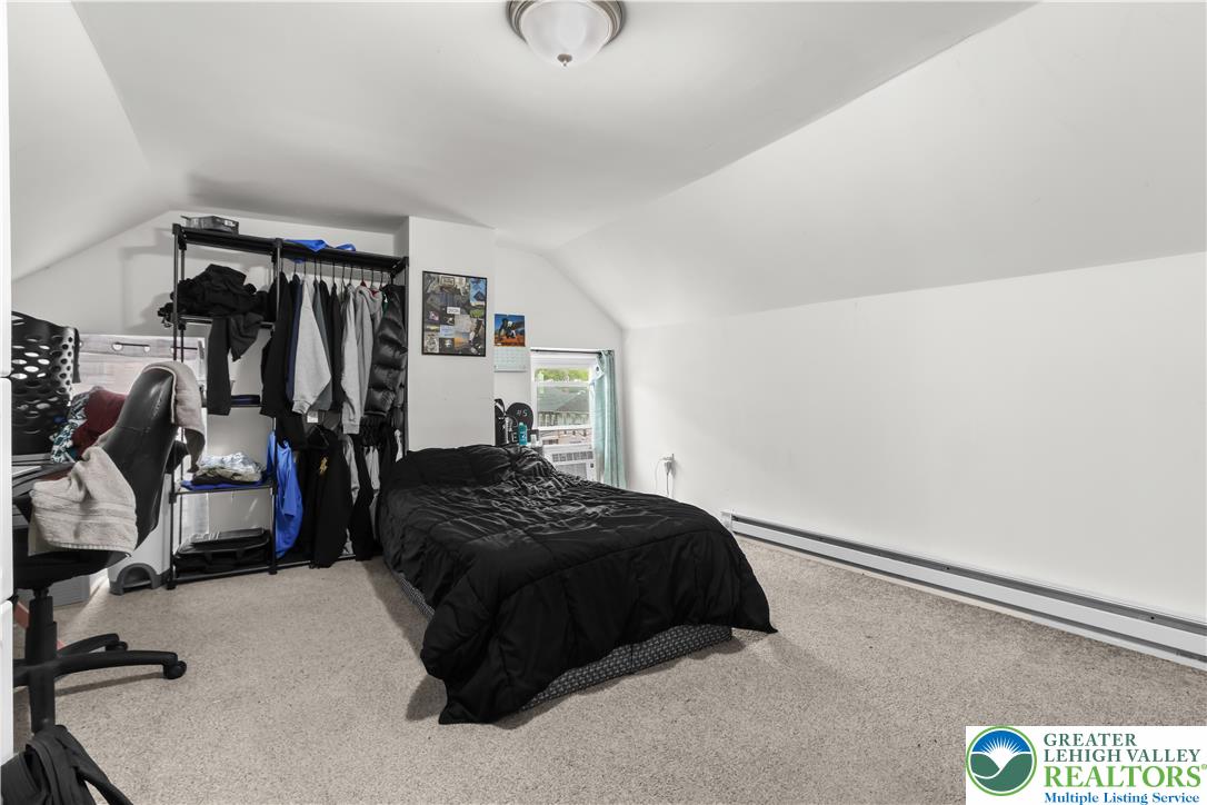 12 South Front Street Coplay, PA 18037 - Photo 14 of 41 This cozy bedroom features sloped ceilings and ample space, perfect for tranquil repose.