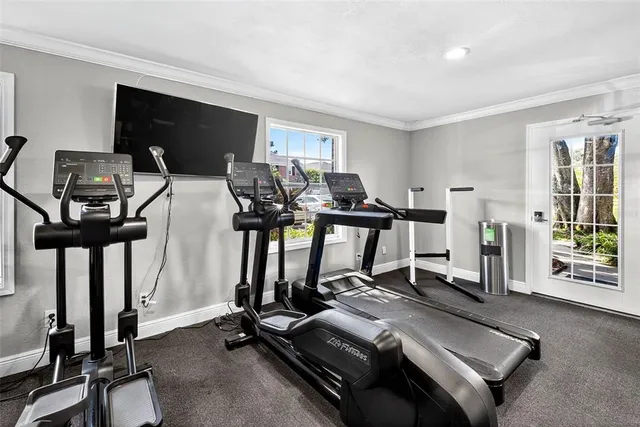 a room with gym equipment and a large window