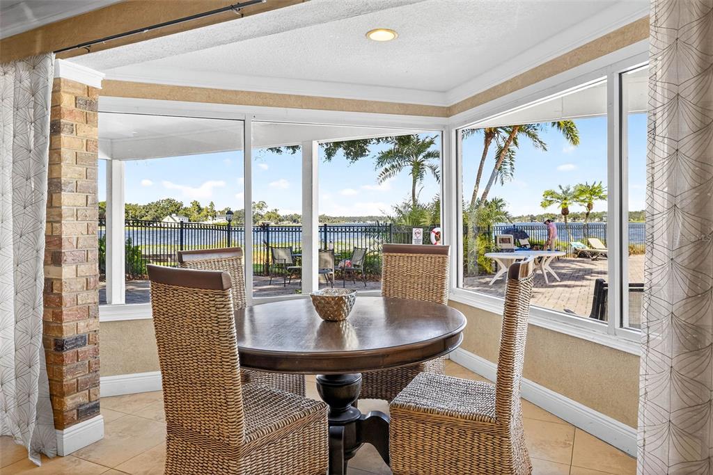 13824 Orange Sunset Drive, Unit 202 Tampa, FL 33618 - Photo 17 of 20 a dining room with furniture wooden floor and a potted plant