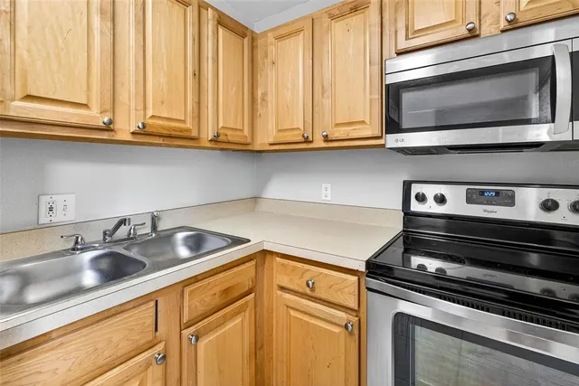 a kitchen with stainless steel appliances granite countertop a sink and cabinets