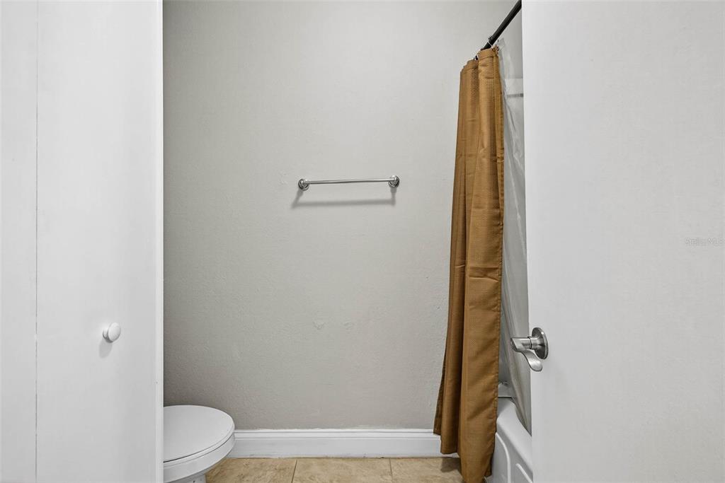 13824 Orange Sunset Drive, Unit 202 Tampa, FL 33618 - Photo 9 of 20 a bathroom with a granite countertop shower and a toilet