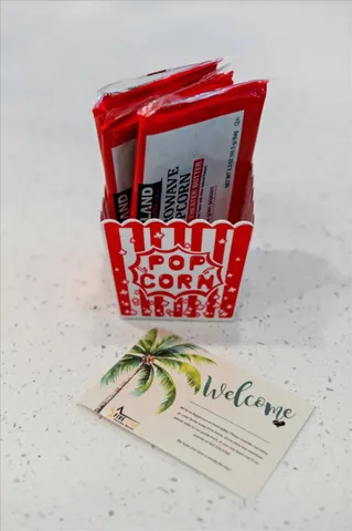 a dining room with wooden floor and a chandelier