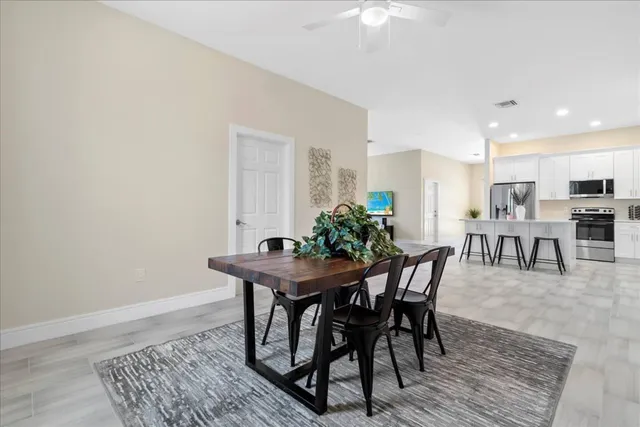 a view of a dining room with furniture and window