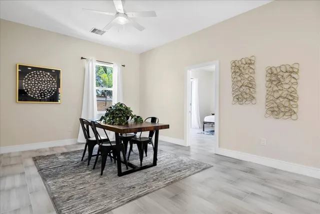 a spacious bedroom with a bed a table and chair