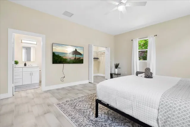 a bed sitting in a bedroom next to a window