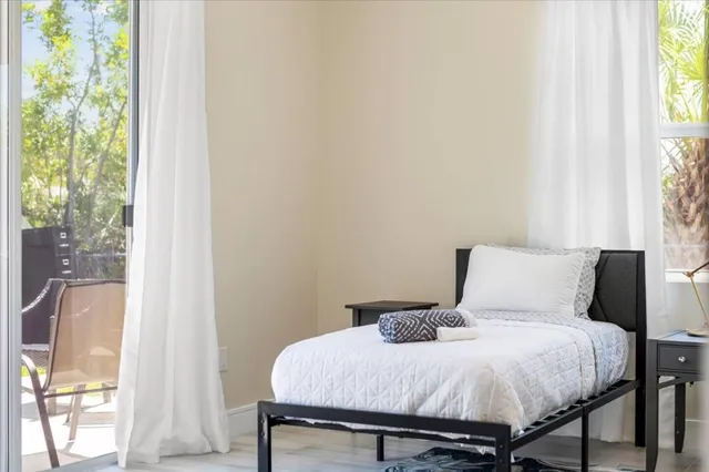 a bedroom with a bed and a window