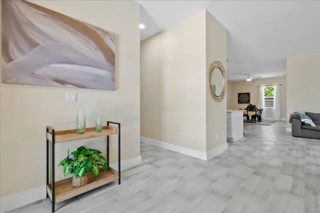 a open kitchen with white cabinets and stainless steel appliances