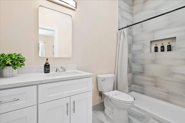 a bedroom with two beds and large windows