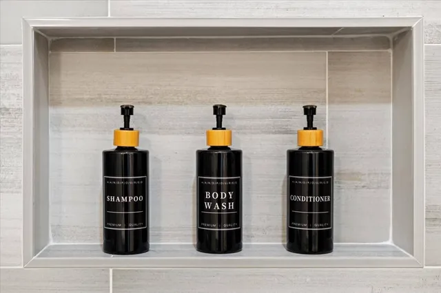 a view of an empty room with a fireplace and window