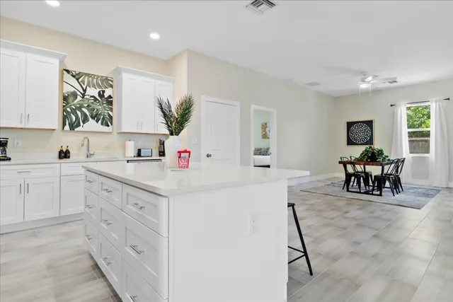 a kitchen with white cabinets and stainless steel appliances