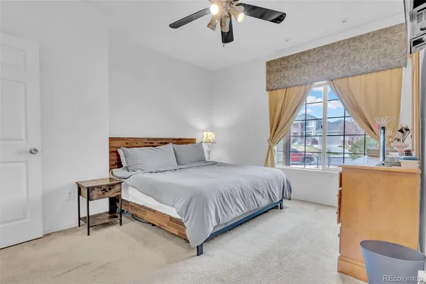 a bedroom with a bed and a large window