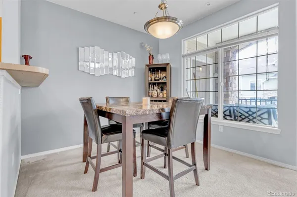 a view of a dining room with furniture and a chandelier