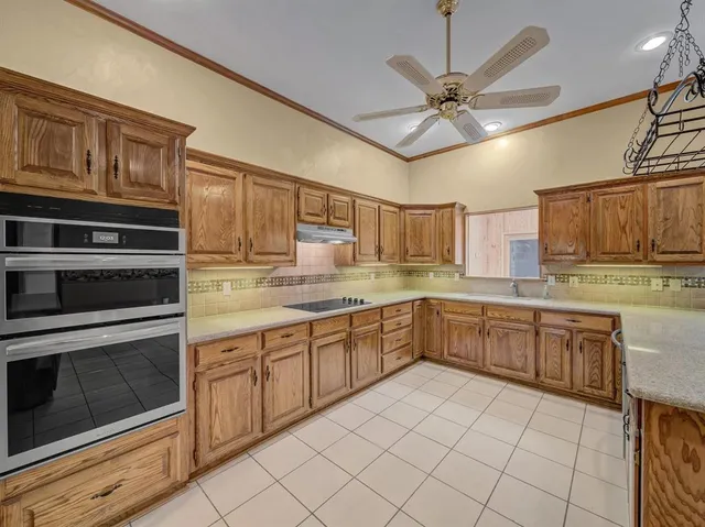 a kitchen with a sink cabinets and stainless steel appliances