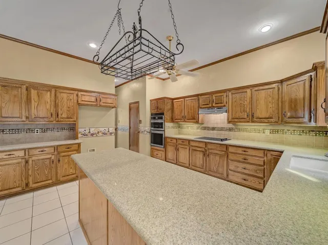 a kitchen with stainless steel appliances granite countertop a sink and cabinets