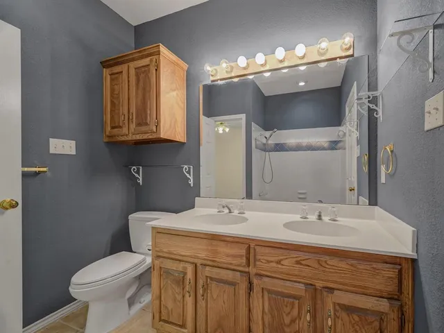 a bathroom with a sink toilet and mirror