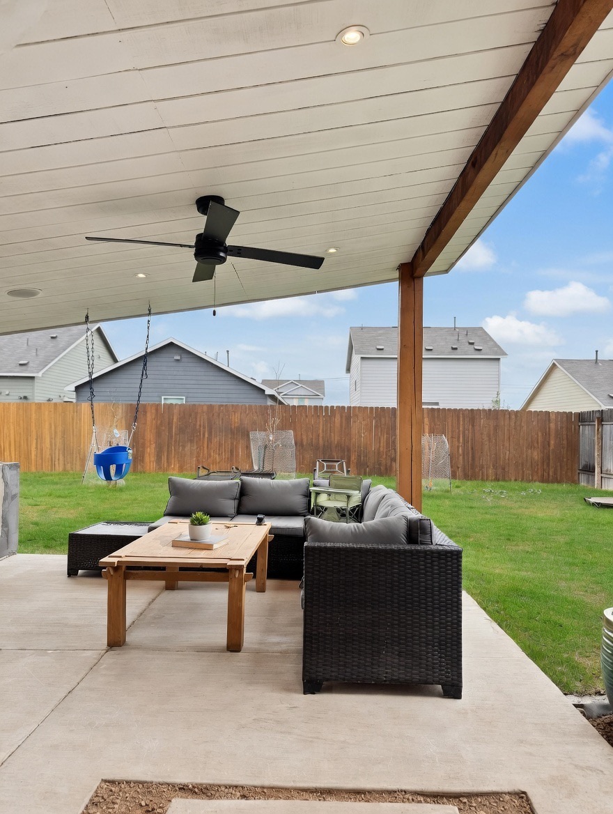 13513 Menard Way Elgin, TX 78621 - Photo 15 of 18 Fenced backyard featuring ceiling fan, a patio area, and outdoor furniture