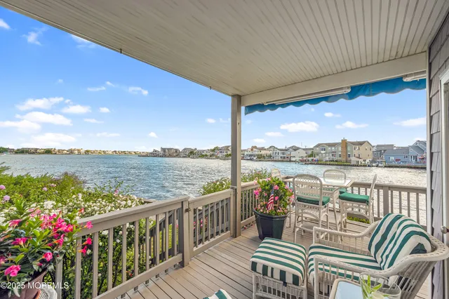 a view of a balcony with wooden floor and outdoor space