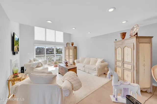a living room with furniture fireplace and a large window
