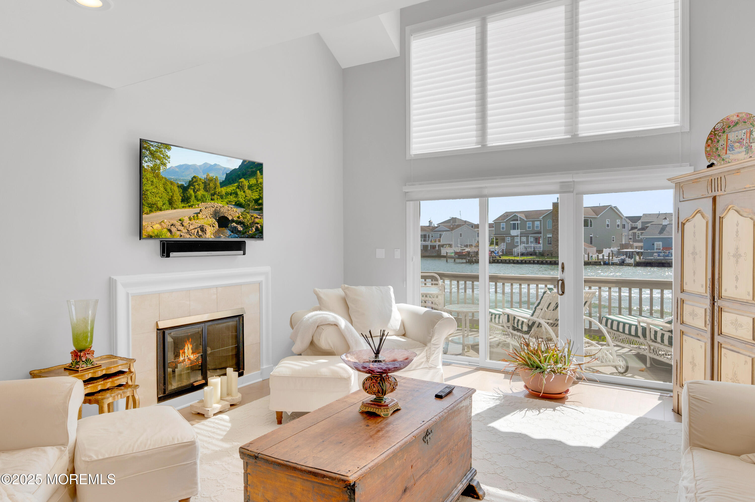 4 Bay Point Harbour Point Pleasant, NJ 08742 - Photo 16 of 46 a living room with furniture a fireplace and a floor to ceiling window