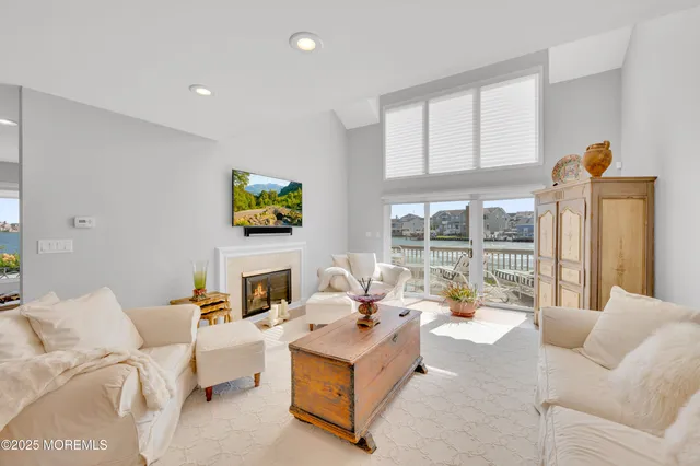 a living room with furniture large window and flat screen tv