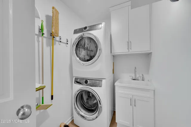 a utility room with sink dryer and washer