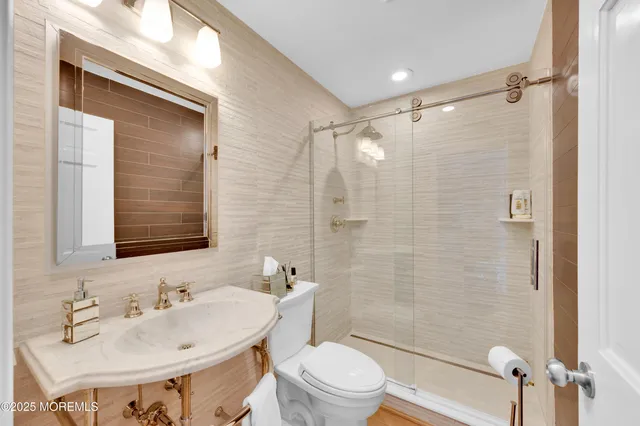 a bathroom with a sink toilet and shower