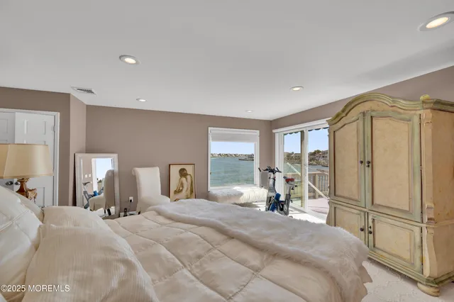 a bedroom with a bed and a large mirror