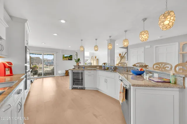 a kitchen with granite countertop a sink stove and cabinets