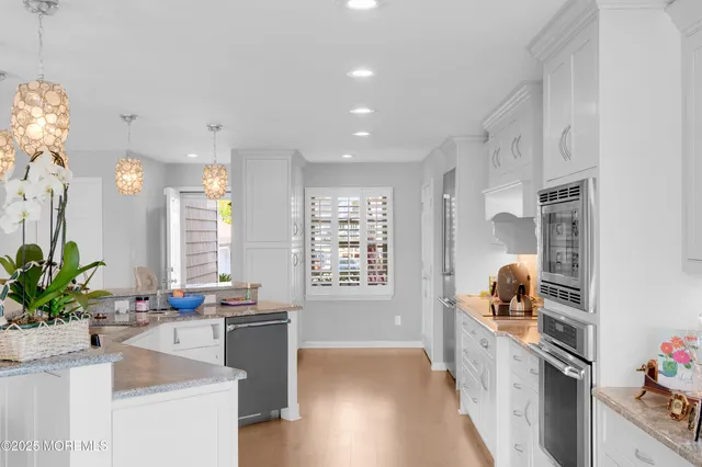 a kitchen with granite countertop a sink stove and cabinets