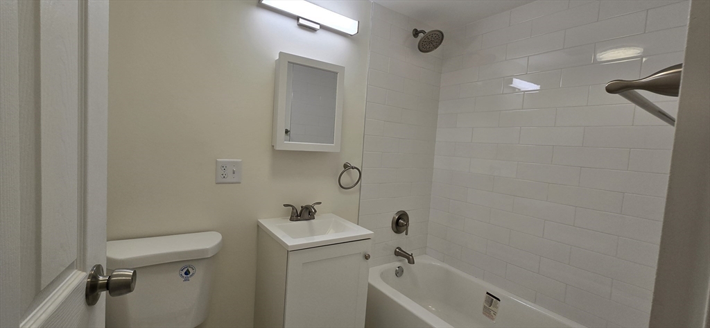 14 Concord Avenue, Unit 312 Cambridge, MA 02138 - Photo 16 of 19 a bathroom with a sink and mirror with toilet