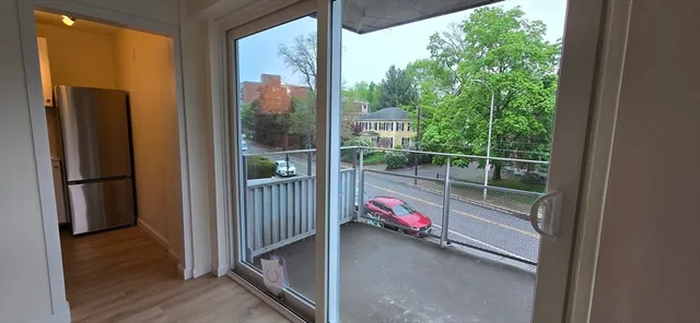 a view of a room with gym equipment and floor to ceiling window