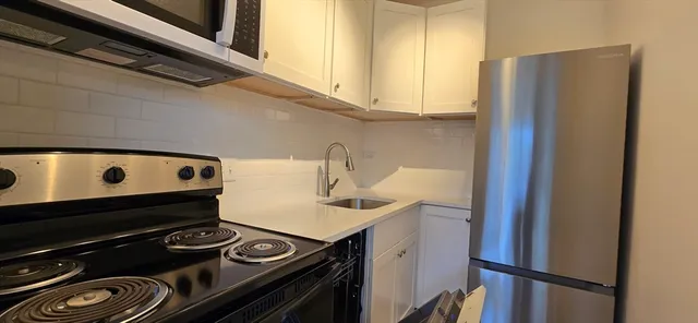 a kitchen with a stove and a refrigerator