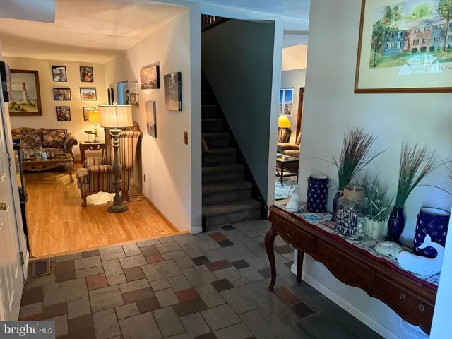 a bedroom with a bed mirror on dresser and a chandelier