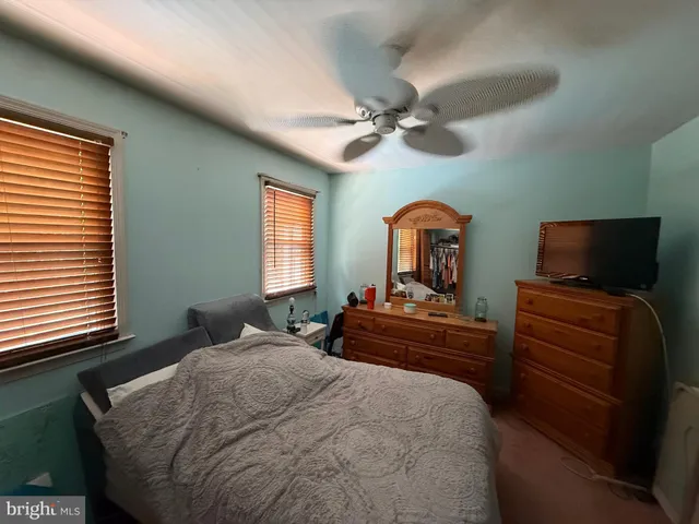 a bedroom with a bed window and couch