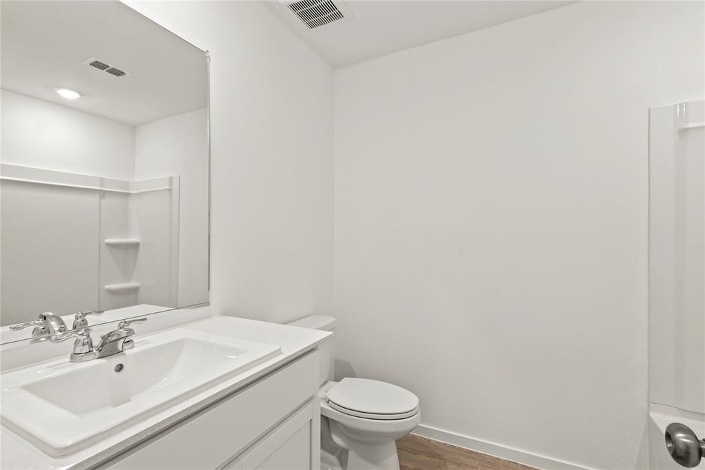 1138 Barbary Flds Street Forney, TX 75126 - Photo 23 of 25 Modern bathroom vanity with integrated sink, chrome faucet, and expansive wall mirror
