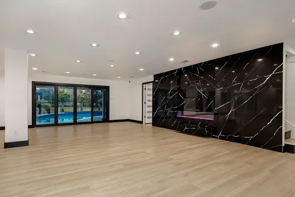a view of an empty room with glass door