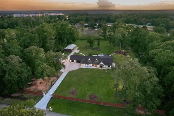 an aerial view of a house with a yard