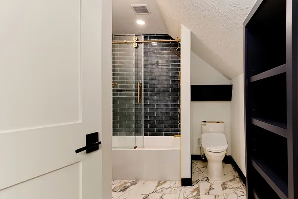 a bedroom with a bed and a mirror