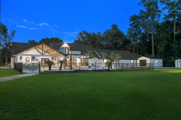 a view of a house with swimming pool and deck