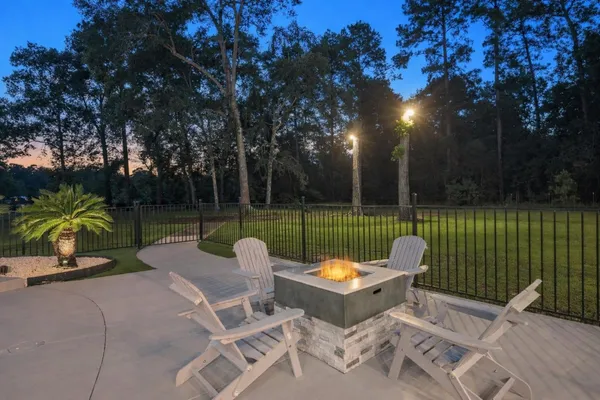 a view of a patio with dining table and chairs