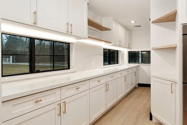 a kitchen with stainless steel appliances refrigerator and cabinets