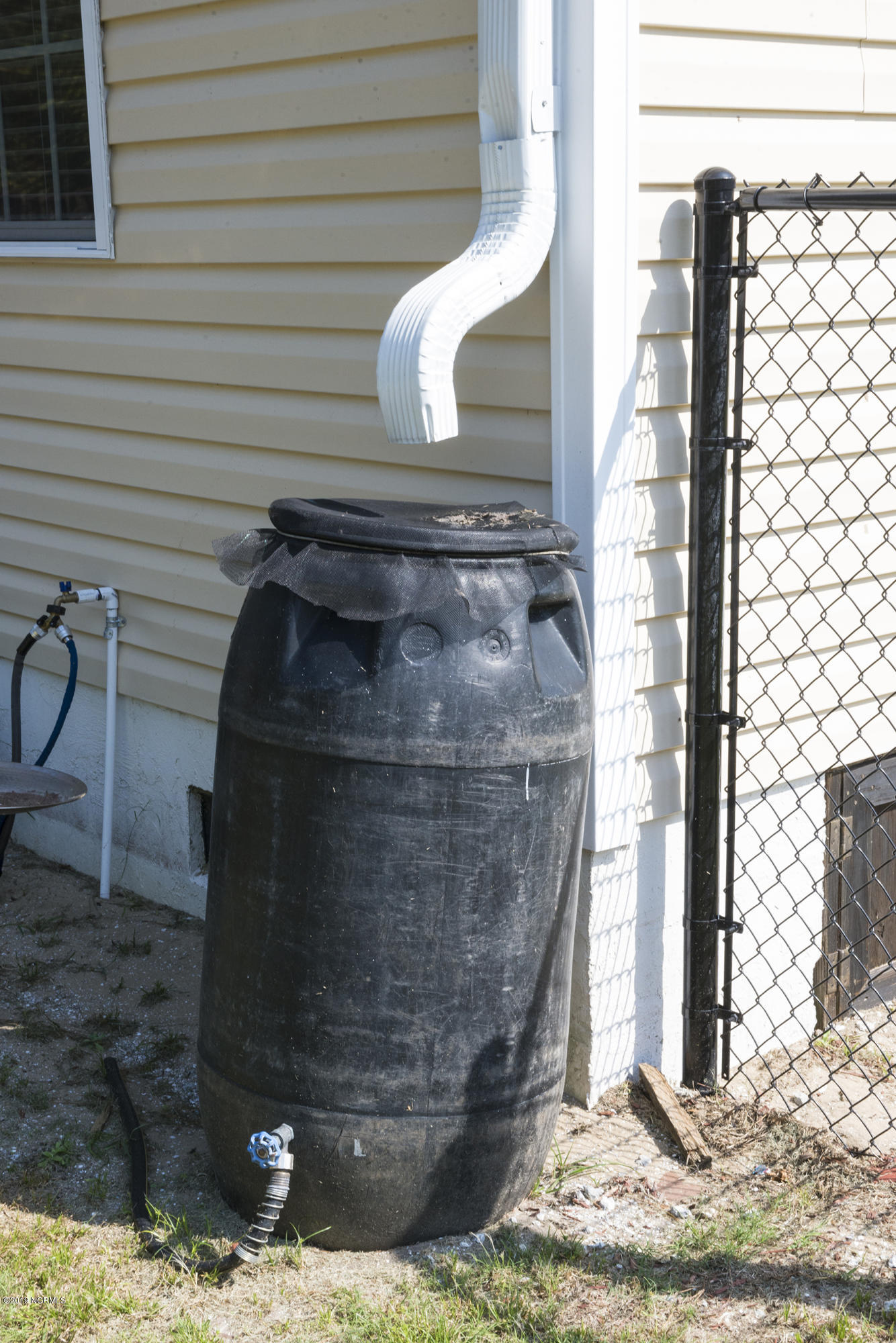 500 Bogue Loop Road Bogue, NC 28570 - Photo 28 of 31 This rain water collection system is attached to hose bibb for watering the lawn.