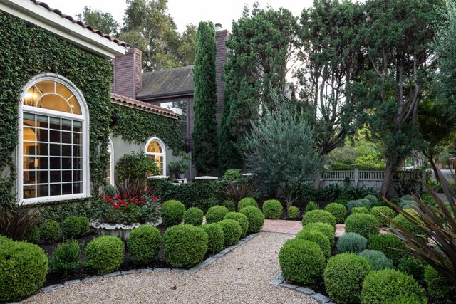 a front view of a house with garden