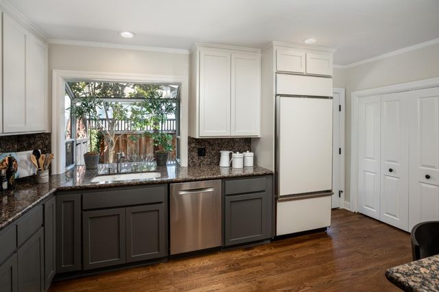 a kitchen with a sink a refrigerator and window