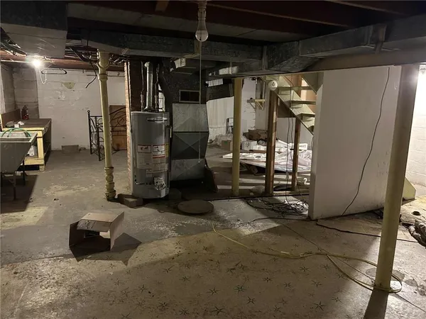 a room with water heater and a refrigerator