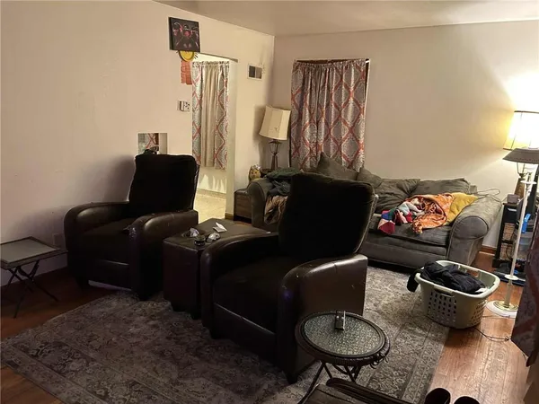 a living room with furniture fireplace and a window