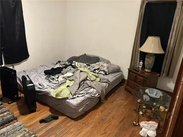 a bed sitting in a bedroom next to a window
