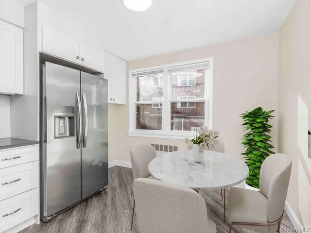 a kitchen with a refrigerator and a table chair