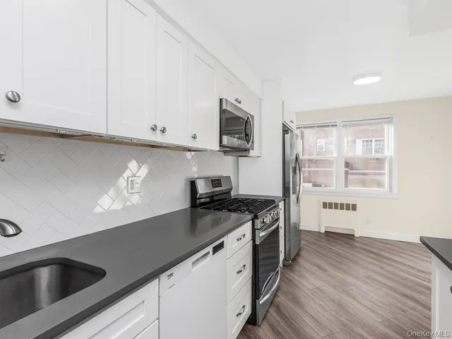 a kitchen with granite countertop a sink and a stove top oven