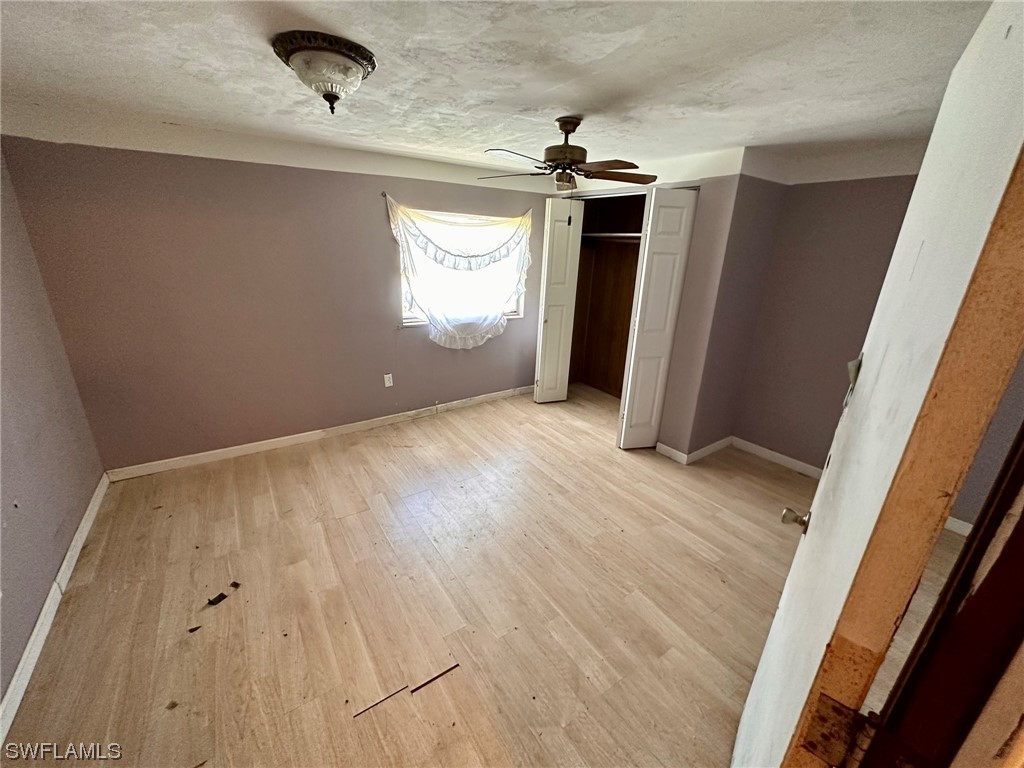 2012 Wright Street Fort Myers, FL 33916 - Photo 13 of 20 an empty room with wooden floor and windows